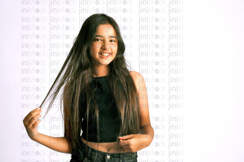 A teen, beautiful girl holding her hair.