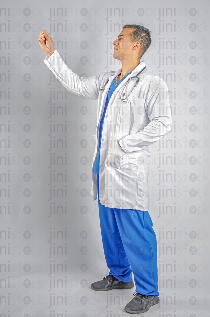 A doctor or physician wearing a white coat and looking at an x- ray