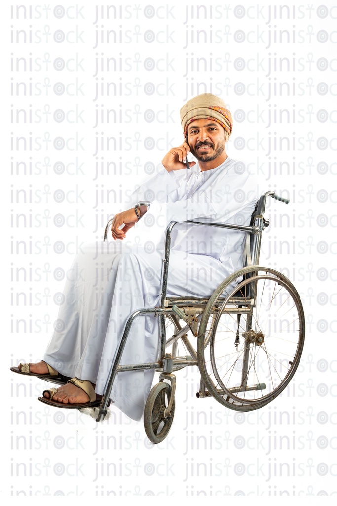 omani arab khaliji man from gulf on a wheelchair talking on the mobile