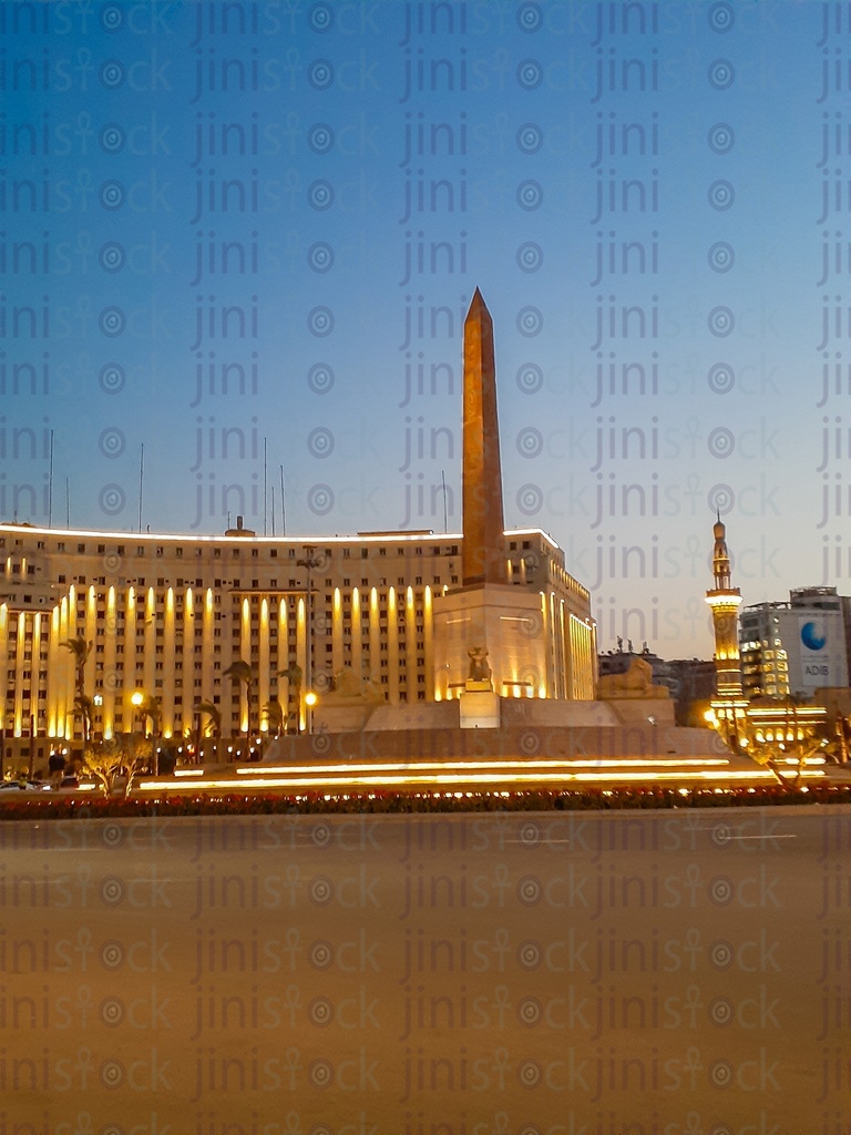 The obelisk, Rams, Tahrir Complex, Omar Makram Mosque in Tahrir Square, Cairo, Egypt at night, and the Street were empty of cars, use as a background for designs on Cairo streets.