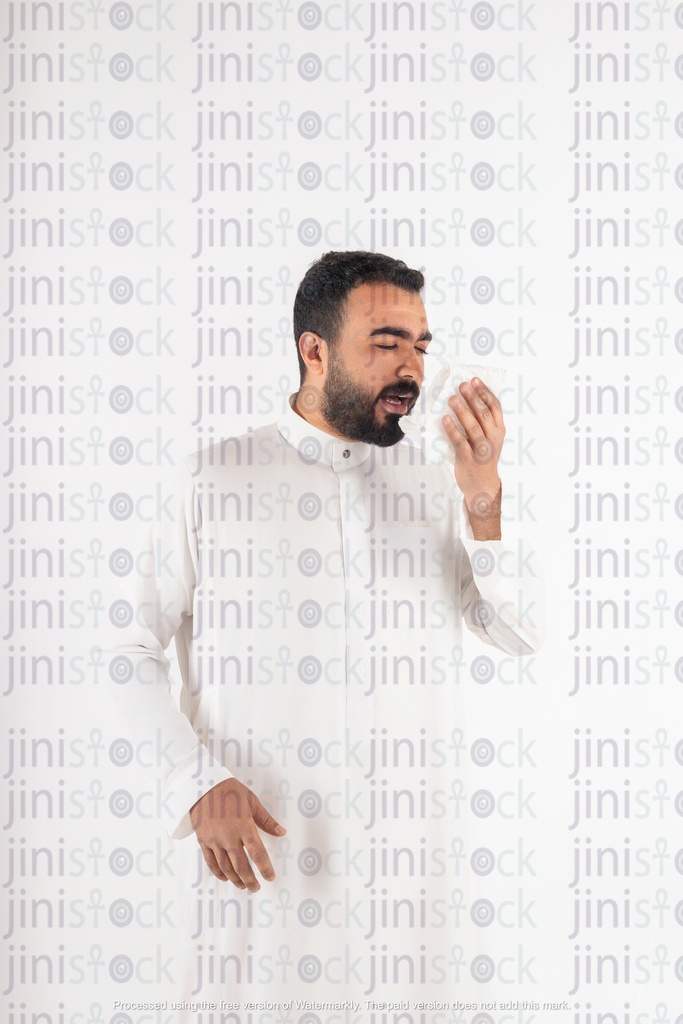 a stock image with high quality of a khaliji saudi from gulf man sneezing