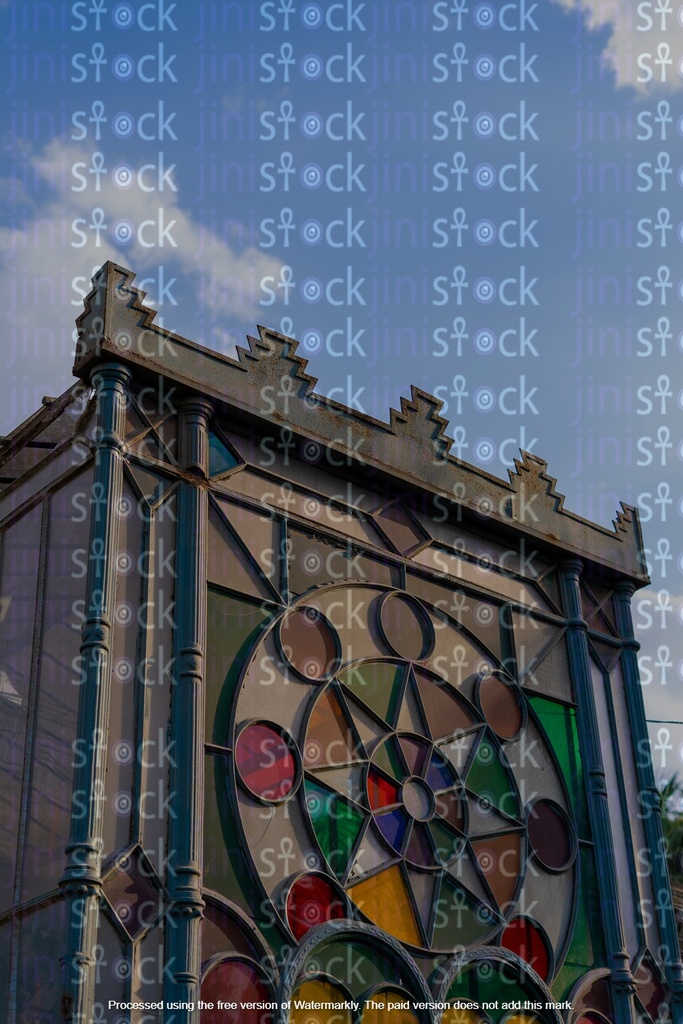 A decorative and colorful glass facade is part of an architectural structure.