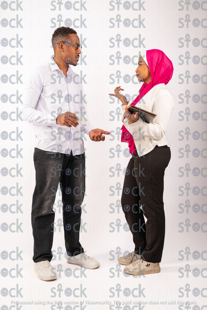 A veiled Nubian girl holding a file talking to a Nubian young man