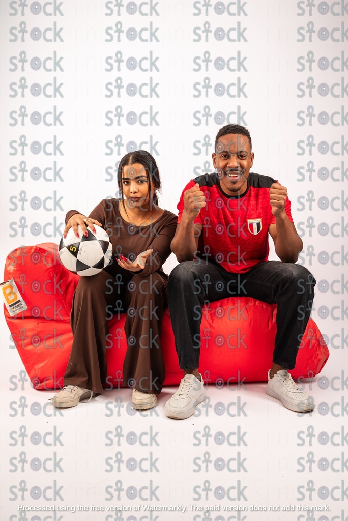 A red bean bag with Nubian football fans sitting on it