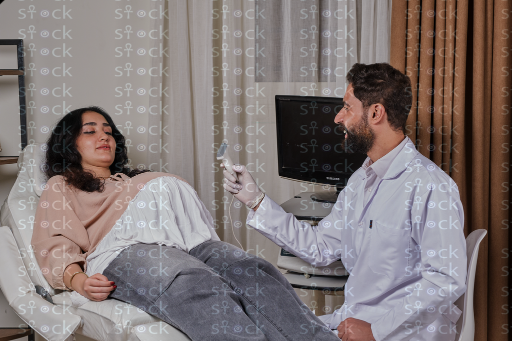 The doctor prepares to examine the patient's abdomen