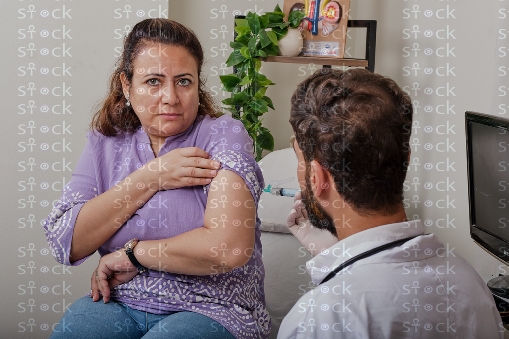 Patient holding her arm in pain