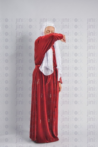 An Egyptian woman sneezing.