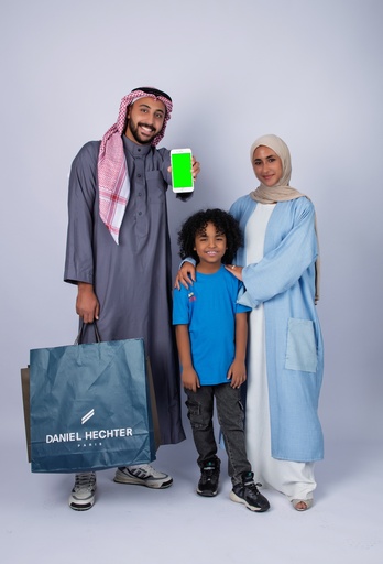 A family is shopping and displaying a mobile app and is happy.