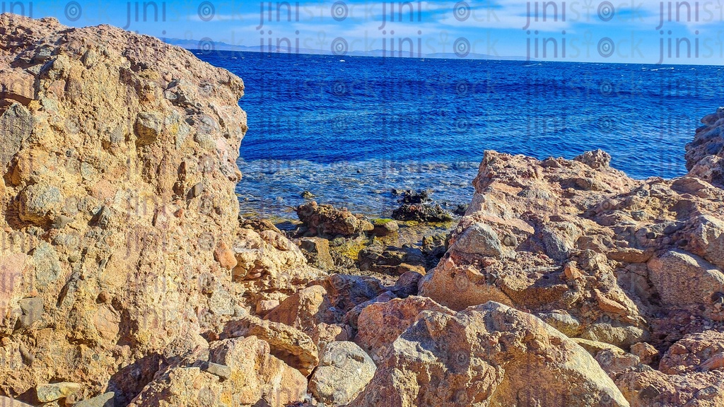 A Beach, rocks, and mountains in Dahab, south Sinai, Egypt | Jini Stock