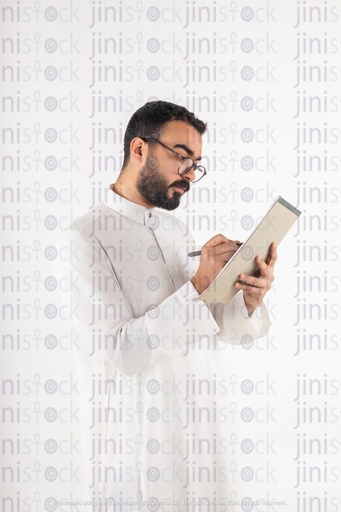 a stock image of a khaliji saudi gulf business man writing on papers
