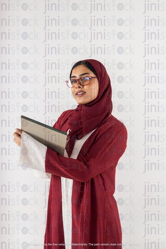 saudi khaliji working from gulf holding a notepad and looking to the camera