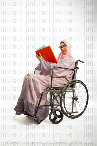 saudi khaliji woman on a wheelchair and working checking a report