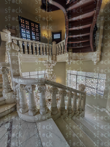 Curved stairs with ornate railing