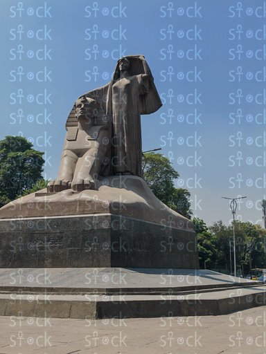A view of the statue with lush greenery in the background